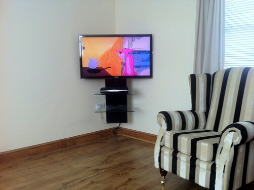 TV Wall Mounted in Corner with AV Shelve System