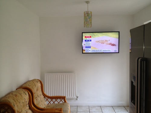 TV Wall Mounted In a Kitchen