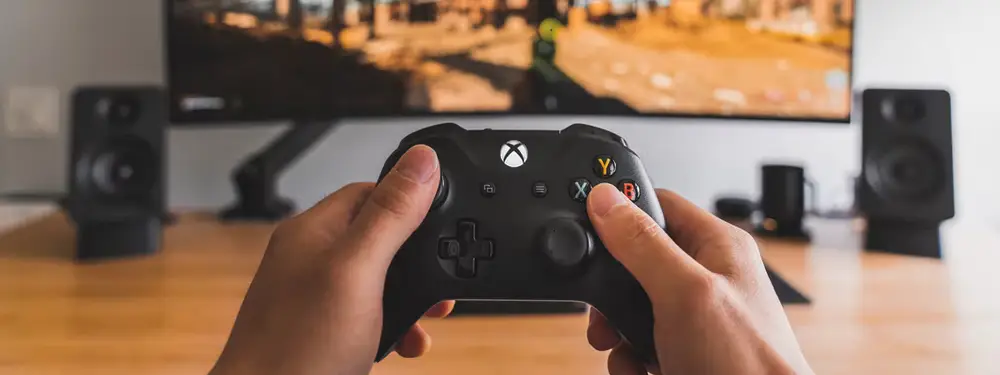 gamer with controller and audio visual system