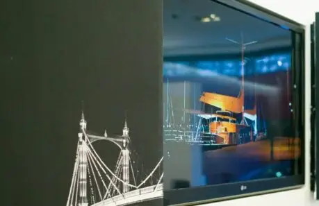 tv hidden behind a pair of pictures that split open to reveal a TV