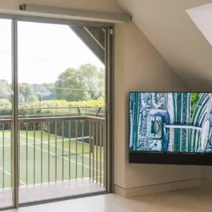 A TV and soundbar mounted in the corner of a room using the future automation DA articulated tv mount