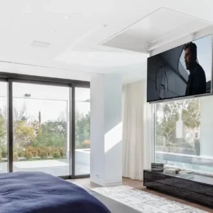 future automation chr tv lift folding down a tv from the ceiling in a modern apartment