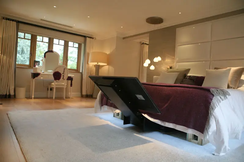 tv sliding out from under a bed with the under bed tv lift