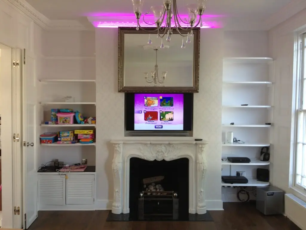 mirror on motorised lift hiding a flat screen tv