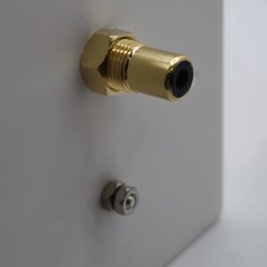 rear of the a subwoofer an ground connection plate with couplers and screw bar for ground