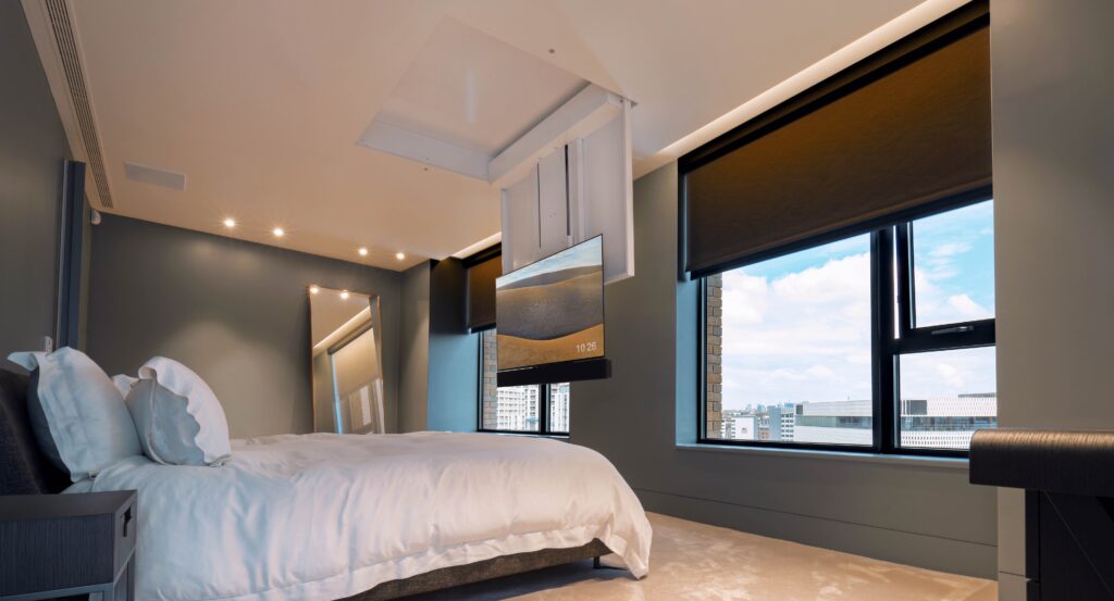 bedroom with a fold down tv lift