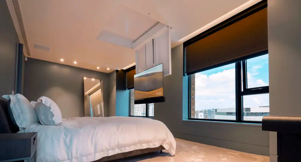 bedroom with a fold down tv lift